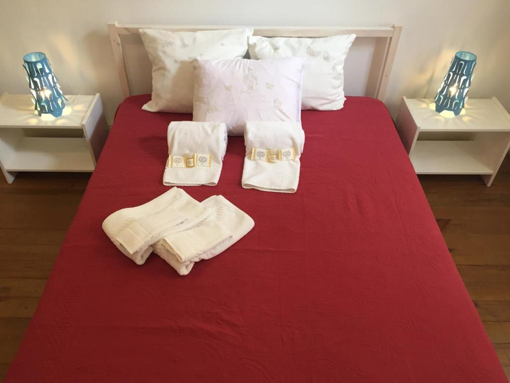 ein Bett mit zwei Handtüchern und zwei Kerzen drauf in der Unterkunft Apartamento Casino Praia II in Figueira da Foz