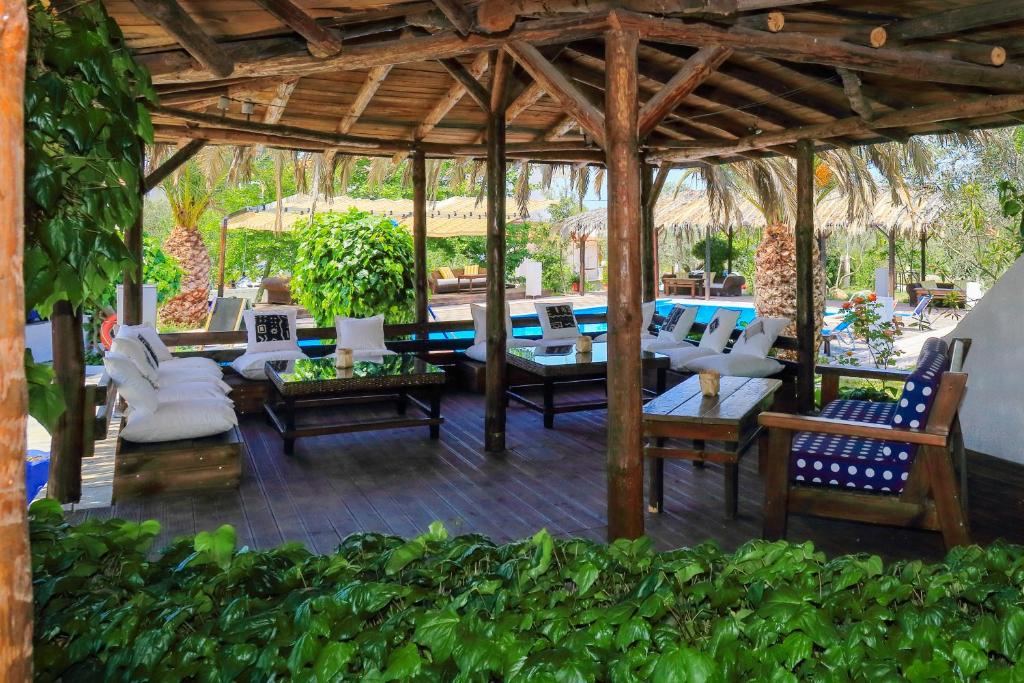 a pavilion with chairs and tables on a patio at Kissos Apartments in Vourvourou
