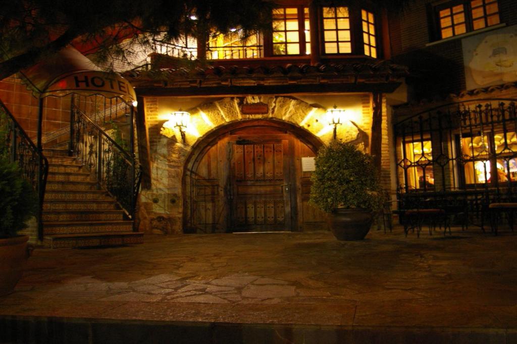 an entrance to a building with a door at night at Hotel Algete in Algete