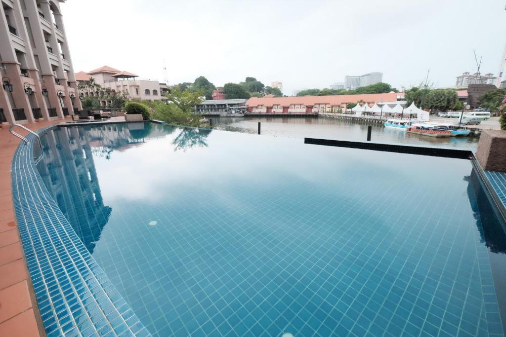 a large swimming pool on the side of a building at Luxury on Melaka River in Malacca