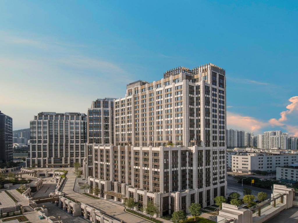 a large building in a city with tall buildings at Residence G Nanshan in Shenzhen