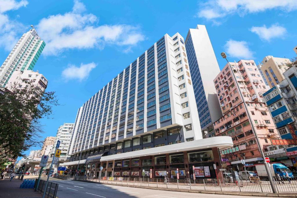 a large building in a city with tall buildings at Metropark Hotel Mongkok in Hong Kong