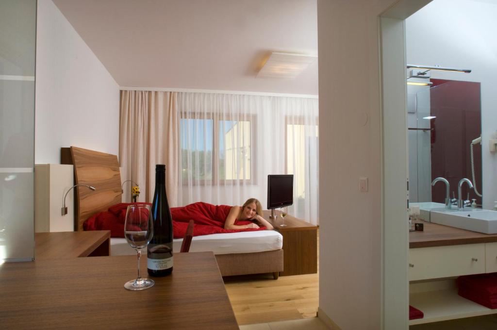 a woman laying on a bed in a room at Winzerhaus Kitzler in Rohrendorf bei Krems