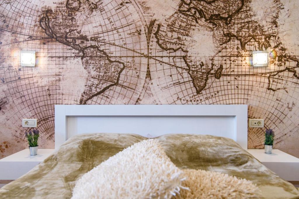 a bedroom with a map of the world on the wall at Villa Jidro in Trogir