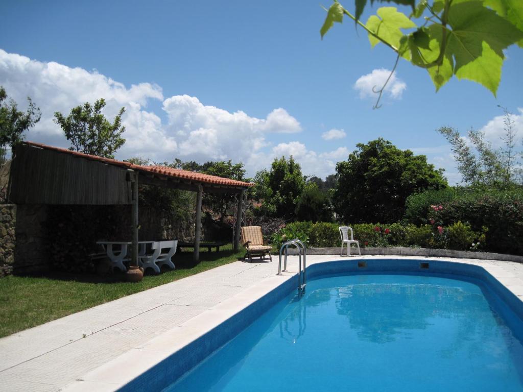 a swimming pool in the backyard of a house at Porto Monte in Maceira