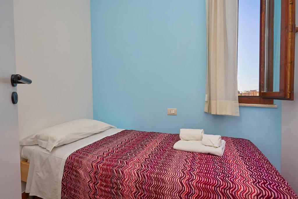 Rúm í herbergi á Residence Favignana