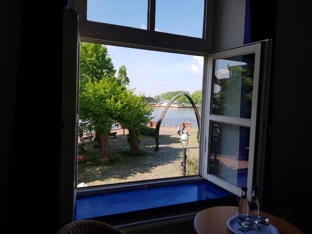 a window view of a beach from a room at Hotel Havenhaus in Bremen-Vegesack