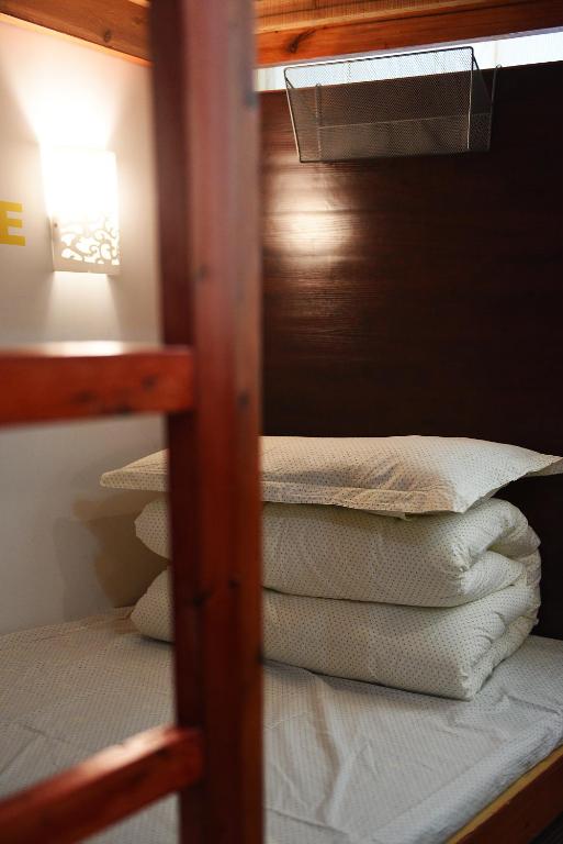 Postel nebo postele na pokoji v ubytování Huangshan Tangkou Haoshi International Youth Hostel