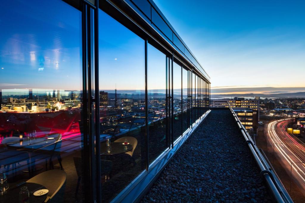 a view of a city from a building with windows at Quality Hotel 33 in Oslo