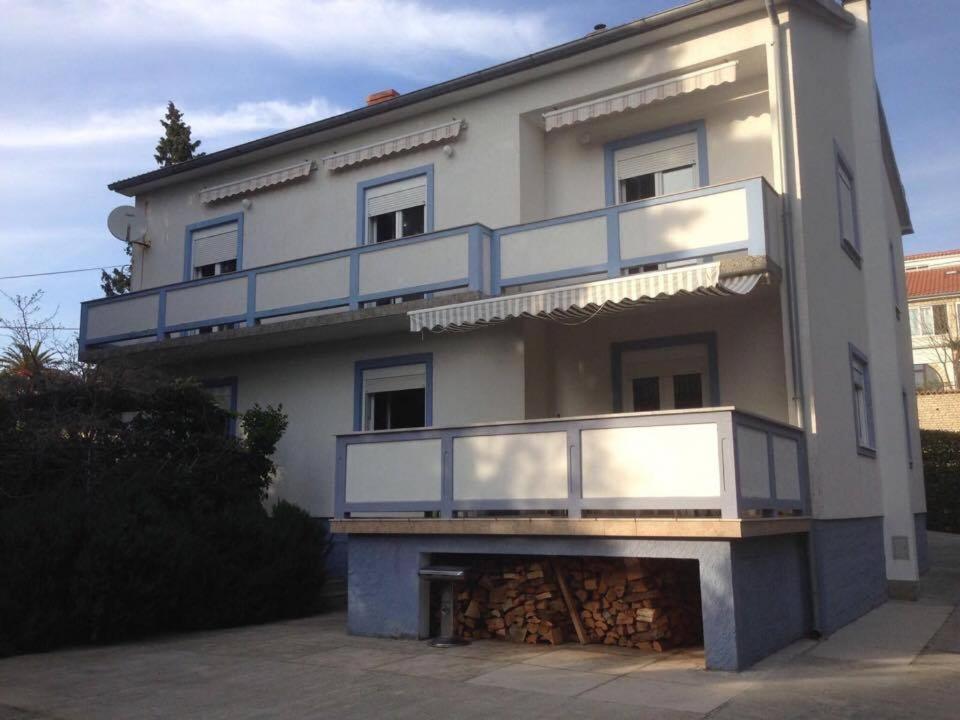 a large white building with a balcony on it at Apartments Lilly Weiss in Banjol
