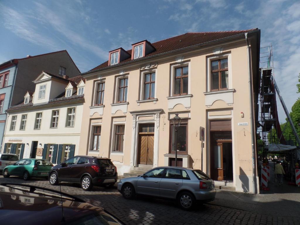 a white building with cars parked in front of it at Ferienwohnung Luise in Potsdam