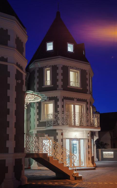 a building with a balcony on the side of it at Castello Boutique Hotel in Čačak