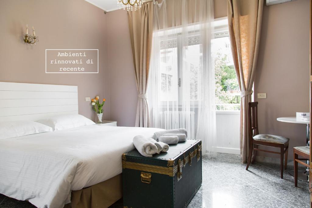 a bedroom with a large bed and a large window at Roma Talenti Breme B&B in Rome