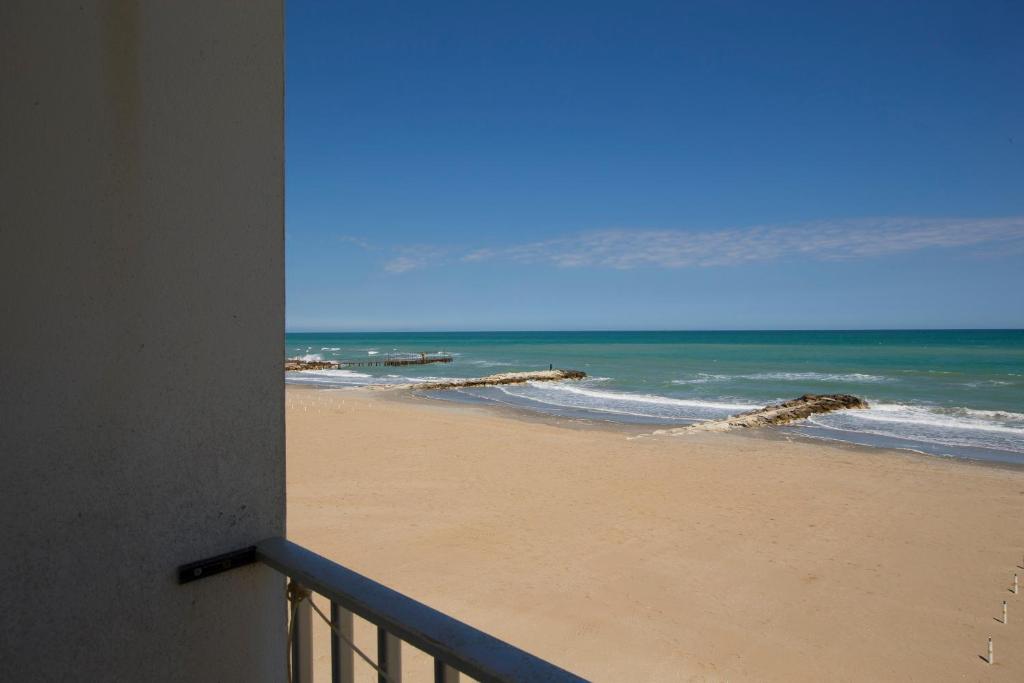 a view of the beach from a balcony at Villa San Francesco in Misano Adriatico