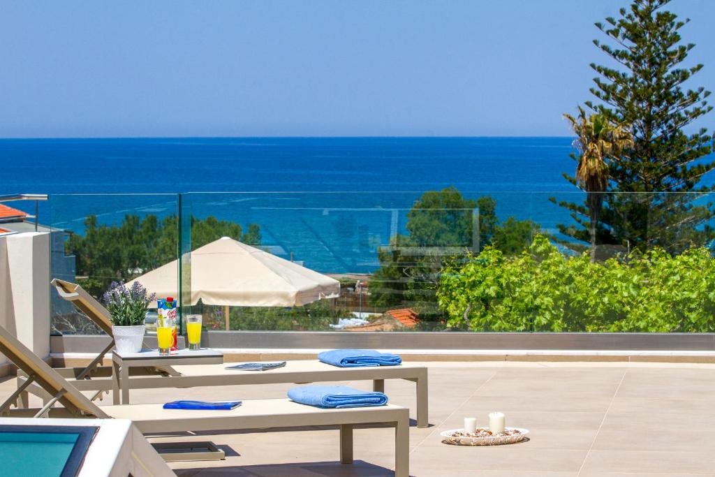 a patio with a view of the ocean at Angels Suites in Platanias