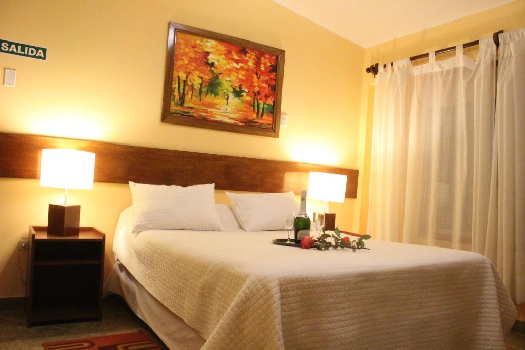 a bedroom with a bed with two lamps on it at Rio Lindo Ecolodge in Lunahuaná