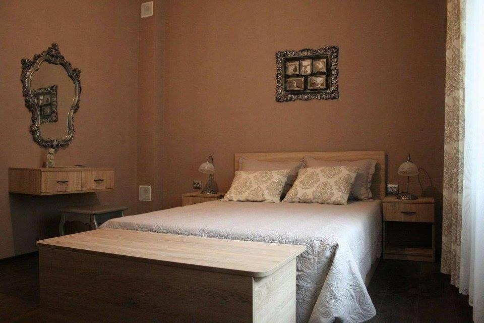 a bedroom with a bed with a mirror on the wall at Yavor Apartment in Sofia