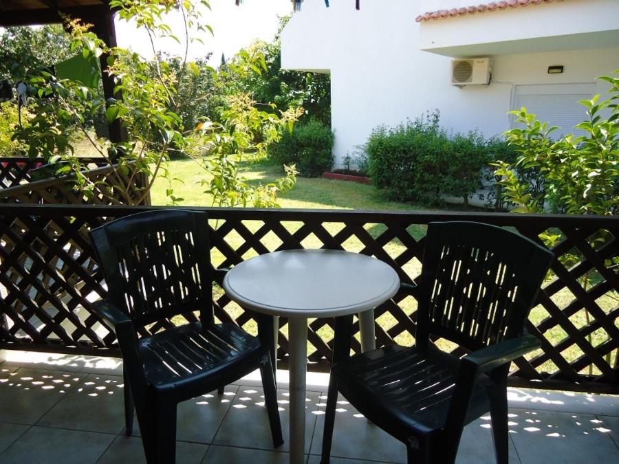 a small table and two chairs on a balcony at Hotel Zachos in Troulos