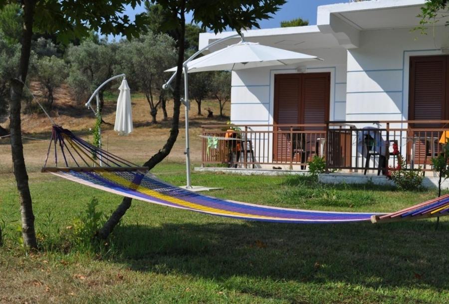 a hammock in a yard in front of a house at Hotel Zachos in Troulos