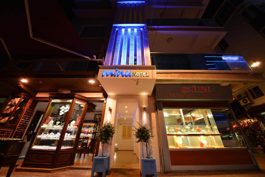 a store with a blue light on the front of it at Minu Hotel in Fethiye