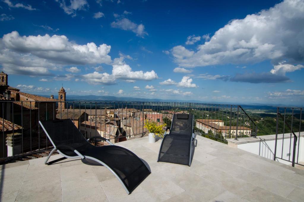 a balcony with a view of a city at Dimora Dell'Erbe Apartment in Montepulciano