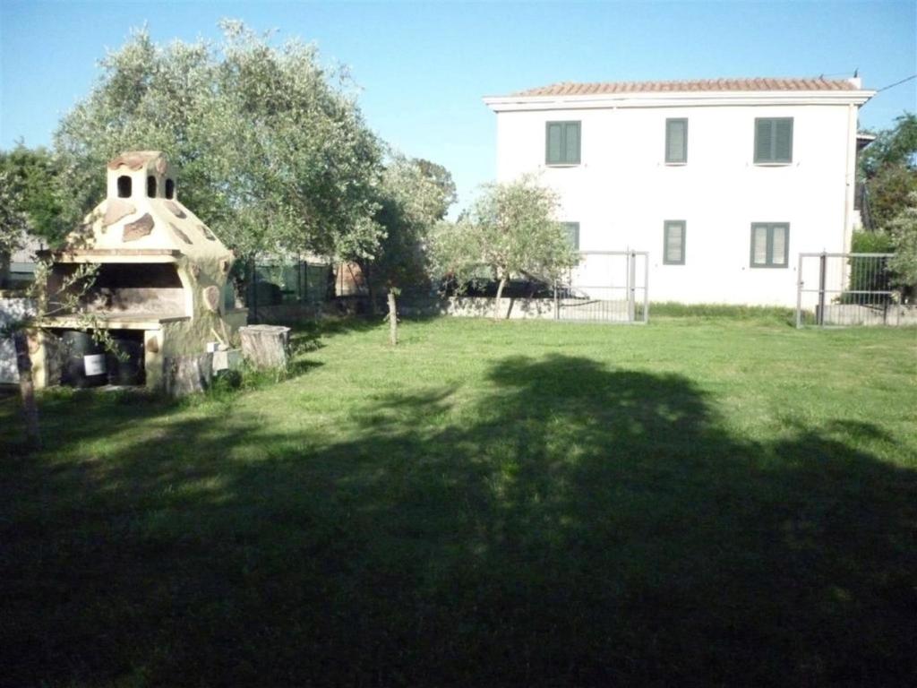 a house and a yard with a building at Deiana's Apartment - Cardedu Beachside in Cardedu