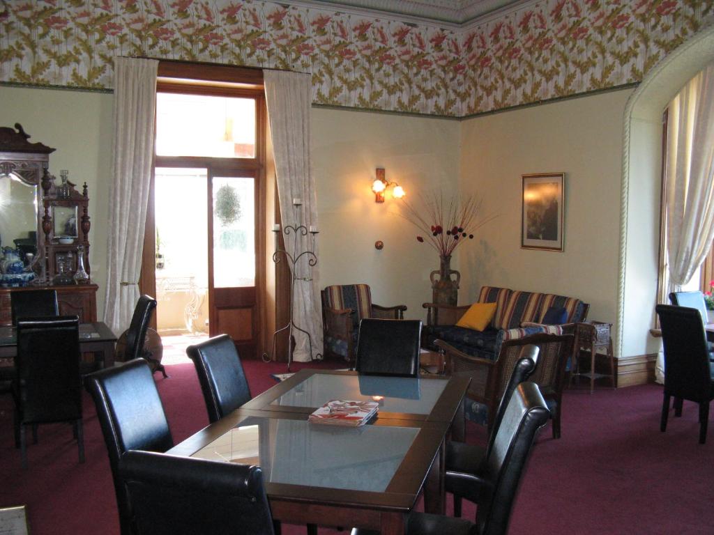 a dining room with a table and chairs at Ugbrooke Country Estate in Lower Dashwood