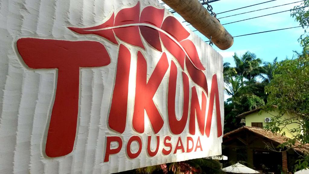 a sign for the kum pucada restaurant at Pousada Tikuna in Itacaré