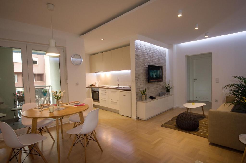 a kitchen and living room with a table and chairs at Paula Apartment in Zagreb