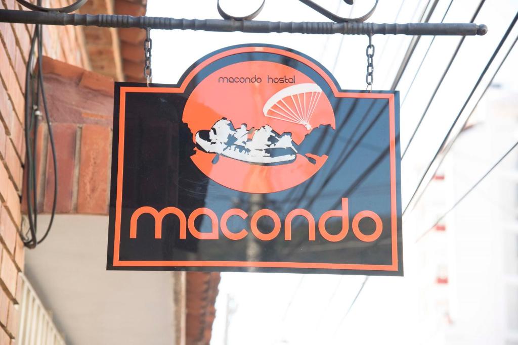 a sign for a moomo restaurant hanging from a building at Macondo Hostel in San Gil