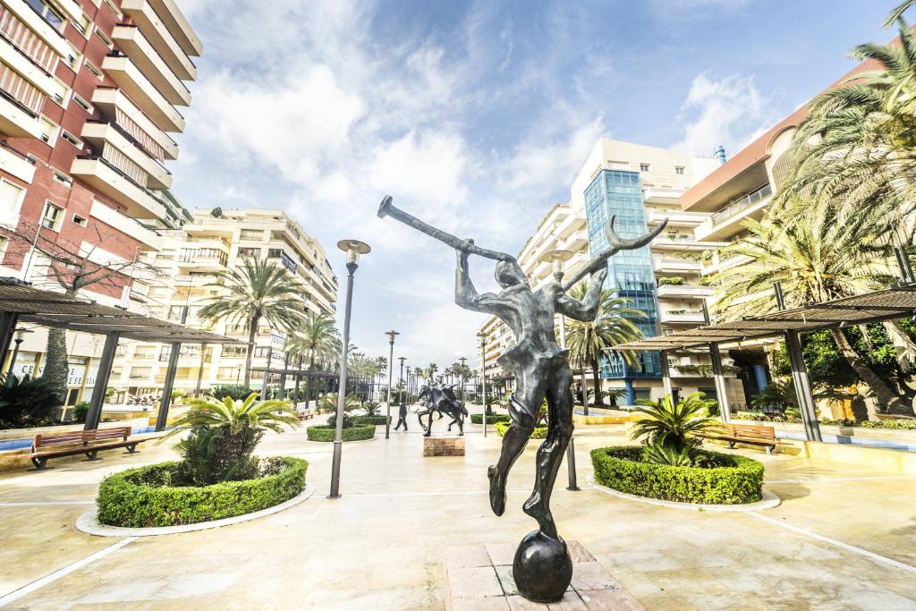 a statue of a man with a telescope at Óbal Hotel Marbella in Marbella