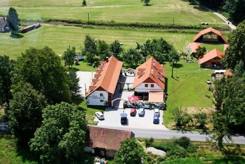 an aerial view of a house with cars parked in the driveway at Penzion Kaminek in Nové Hrady