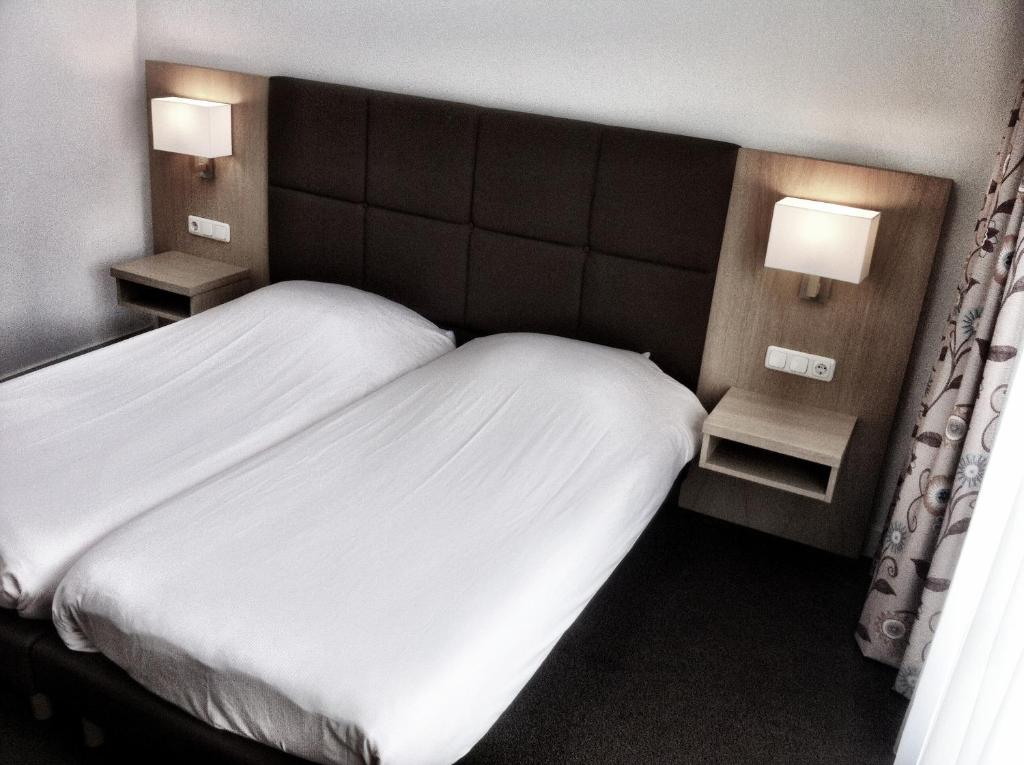 Postel nebo postele na pokoji v ubytování Hotel Bos en Duinzicht