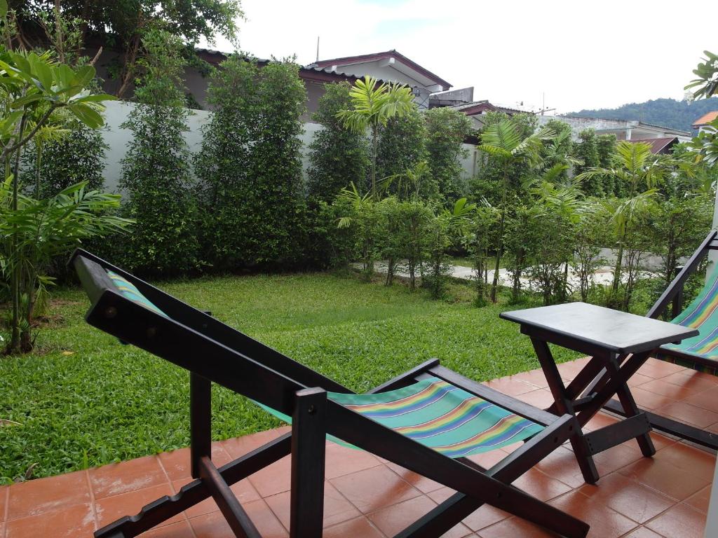 a chair and a table on a patio at Crystal Lamai Hotel in Lamai