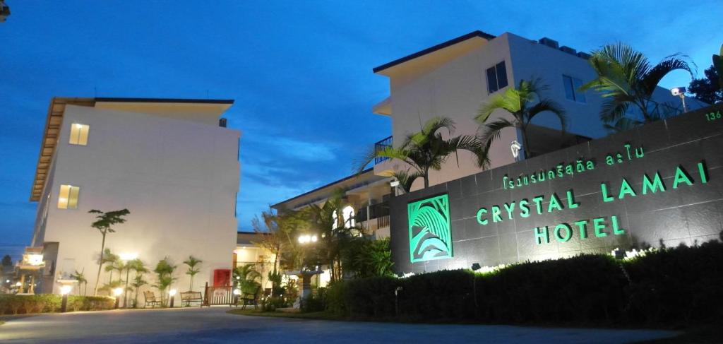 a hotel sign in front of a building at Crystal Lamai Hotel in Lamai