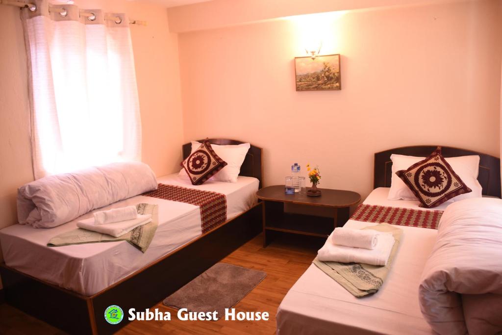 Postel nebo postele na pokoji v ubytování Subha Guest House