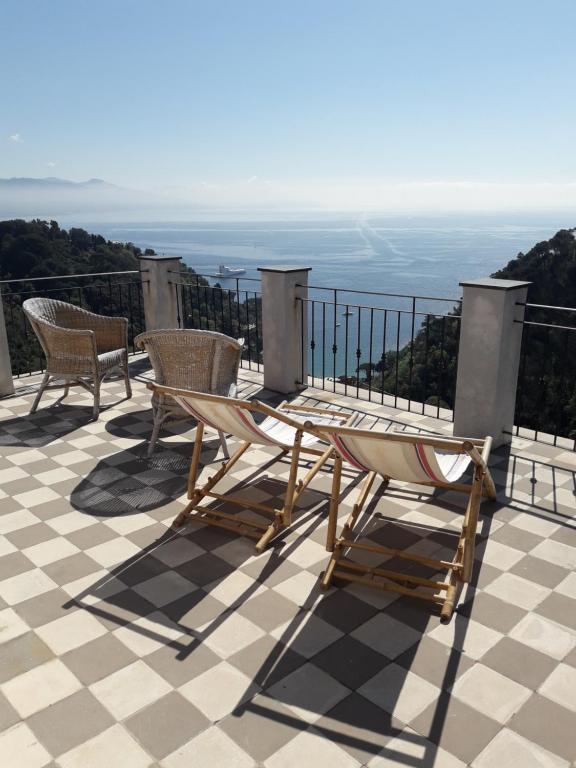 a patio with chairs and a table on a roof at Trekking in paradise B&B in Santa Margherita Ligure