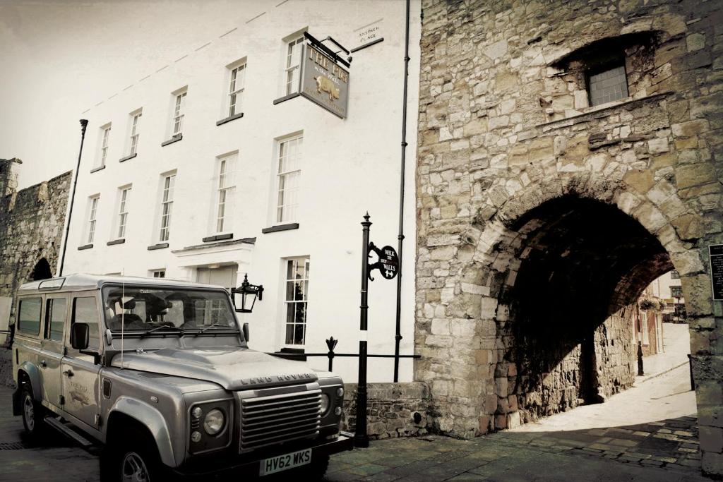 an old truck parked in front of a stone building at THE PIG-in the wall in Southampton