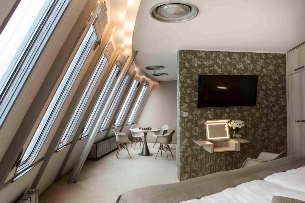 a hotel room with a bed and a table at Hotel Ještěd in Liberec