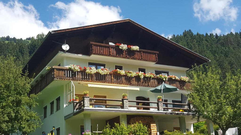 ein Gebäude mit einem Balkon mit Blumen darauf in der Unterkunft Gästehaus Hauser in Bach