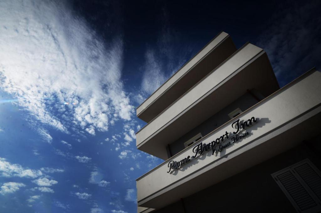 a building with the sky in the background at Rome Airport Inn in Fiumicino
