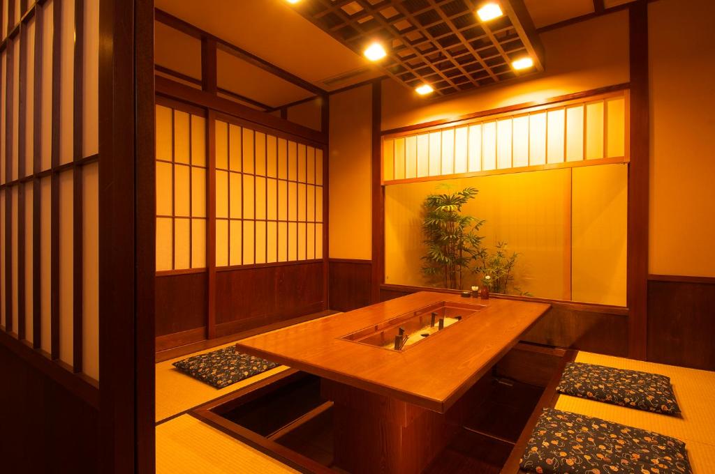 Una habitación con una mesa de madera con una planta. en Kaiyu Notonosho, en Wajima