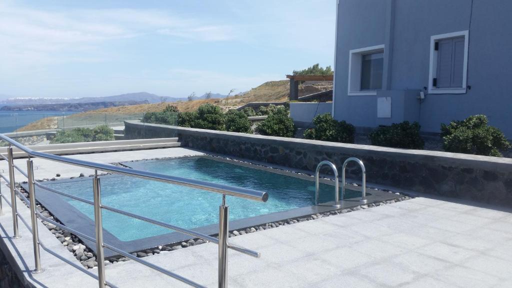a swimming pool on the side of a house at Our Villa Santorini in Akrotiri