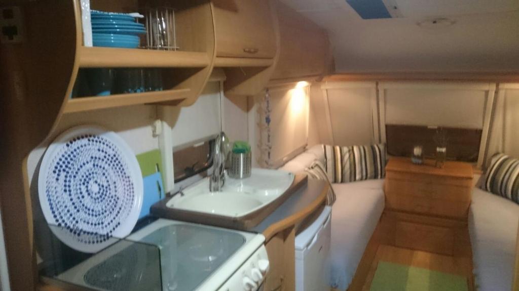 a small kitchen with a sink and a stove at Caravan Apartment in Tinajo