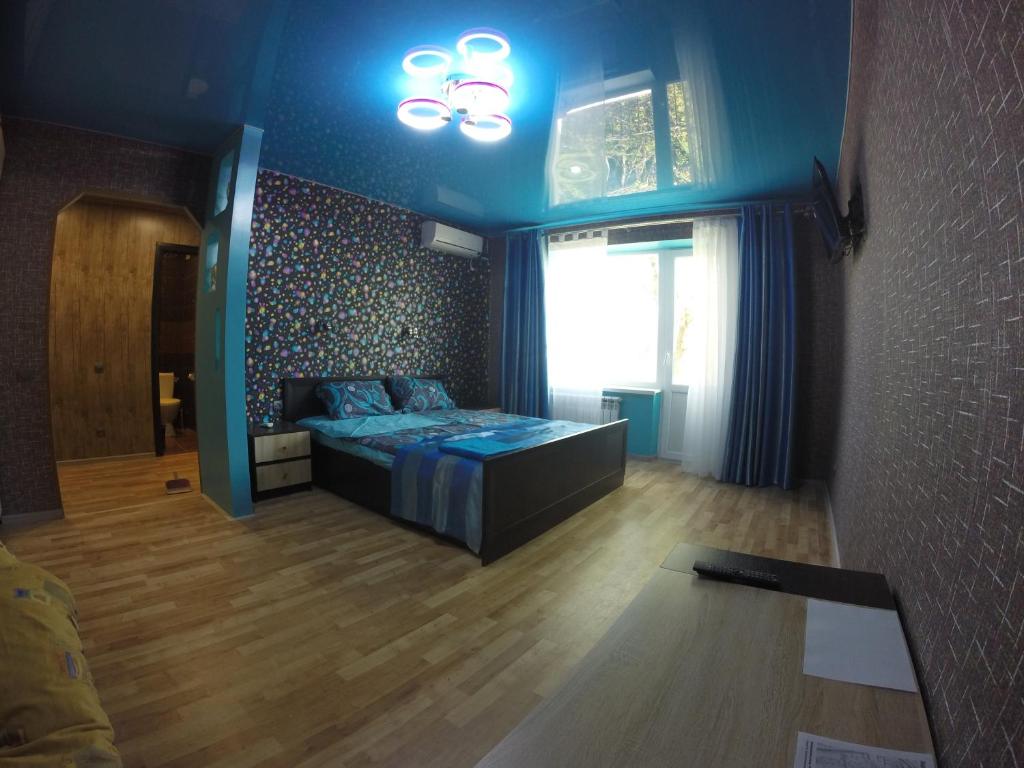 a bedroom with a bed in a room with a window at Apartmens on Khabarovskaya in Kryvyi Rih