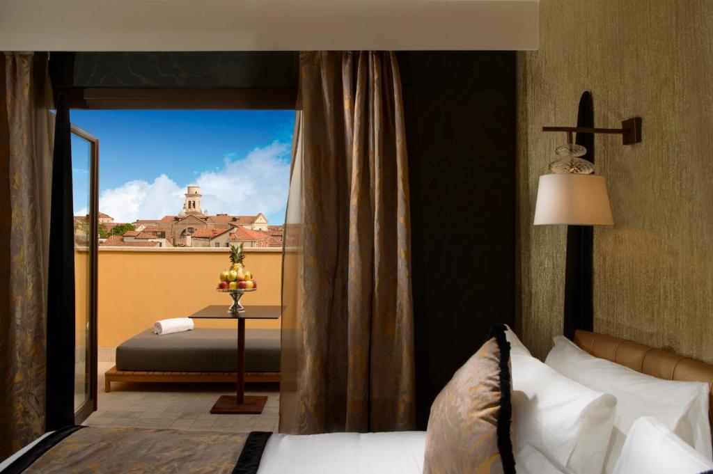 a bedroom with a bed and a window with a view at Palazzo Veneziano - Venice Collection in Venice