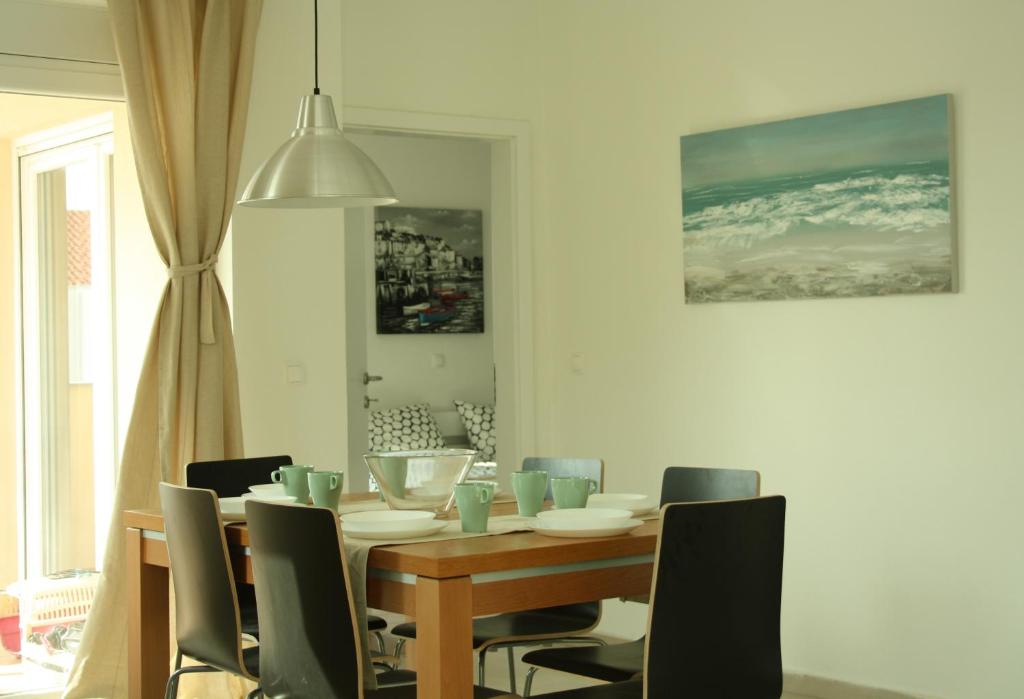 a dining room with a wooden table and chairs at Apartmani Japa in Vrsi