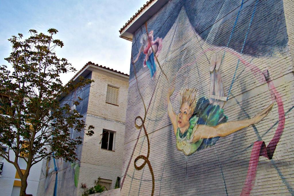 a mural of a woman on the side of a building at Apartamentos Miguel Angel in Estepona