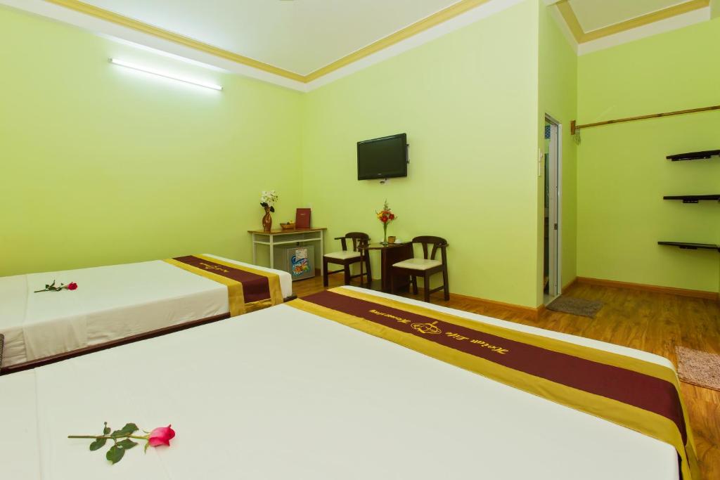 Postel nebo postele na pokoji v ubytování Hoi An Life Villa