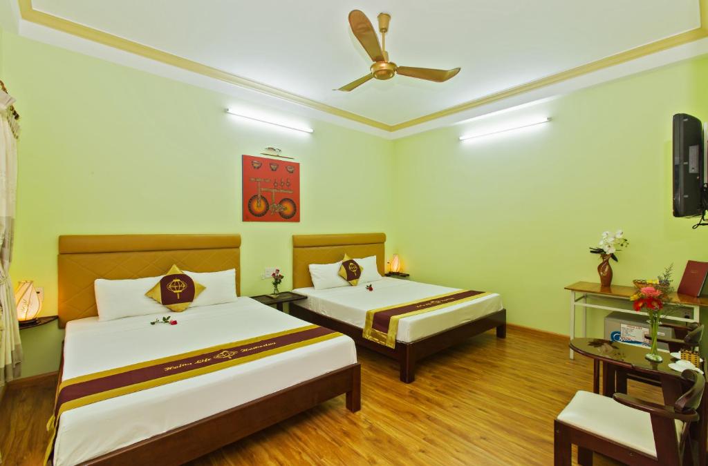 Postel nebo postele na pokoji v ubytování Hoi An Life Villa